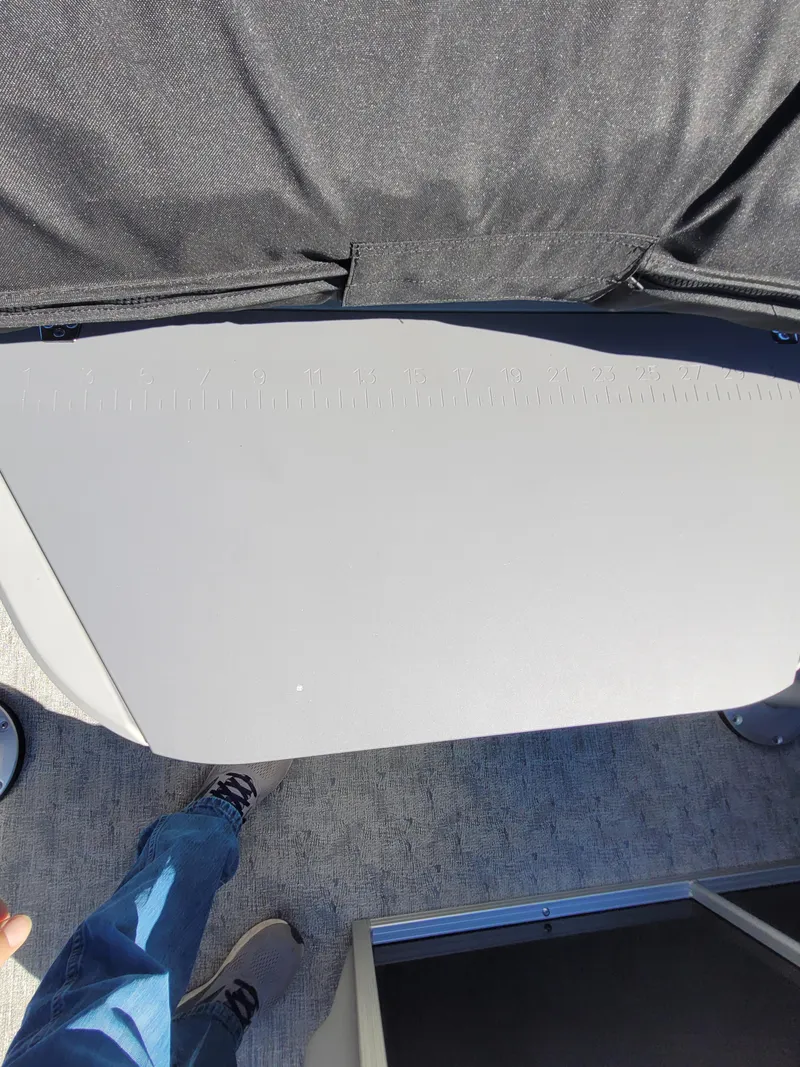 Slide: The Image of 2025 Trifecta 22TRFCLE275 boat interior with gray seating and carpeted flooring. - 16