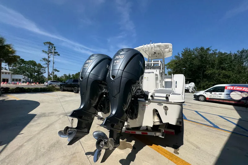 Slide: The Image of 2024 NauticStar 292 Legacy boat with dual Yamaha 300 V6 engines in a sunny outdoor setting. - 14