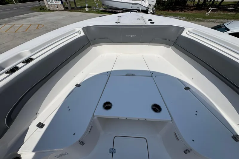 Slide: The Image of 2024 NauticStar 292 Legacy boat interior with spacious seating and cup holders. - 21
