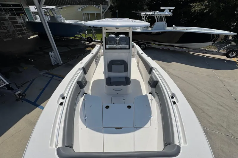 Slide: The Image of 2024 NauticStar 292 Legacy boat, white interior, docked at marina, showcasing spacious seating. - 22
