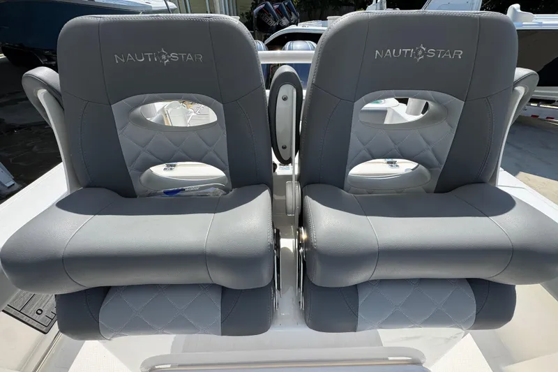 Slide: The Image of 2024 NauticStar 292 Legacy boat seats, featuring gray quilted upholstery and branded logo. - 27