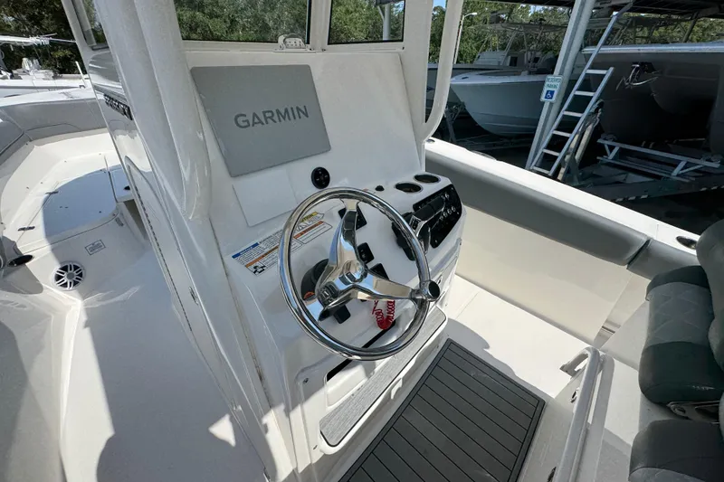 Slide: The Image of 2024 NauticStar 292 Legacy boat helm with Garmin navigation system. - 29