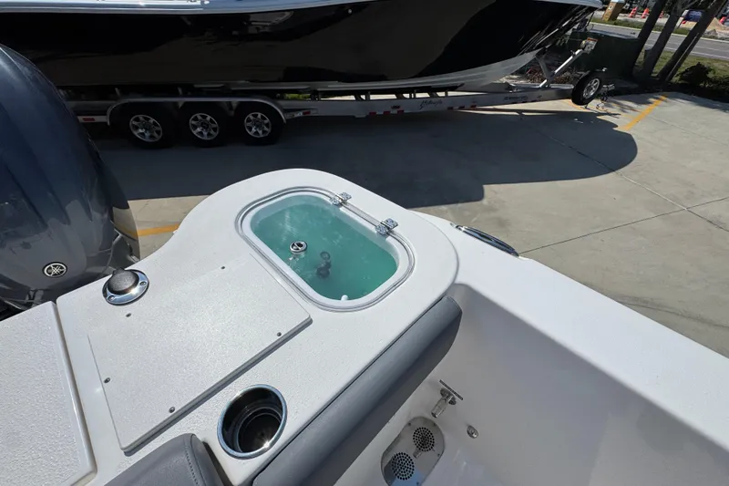 Slide: The Image of 2024 NauticStar 292 Legacy boat with livewell and Yamaha engine, parked on trailer. - 35