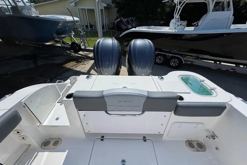 Slide: The Image of 2024 NauticStar 292 Legacy boat with dual engines and spacious deck layout. - 37