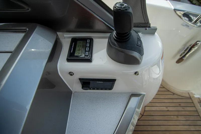 Slide: The Image of 2024 Riviera 4600 SY yacht control panel with joystick and digital display. - 14