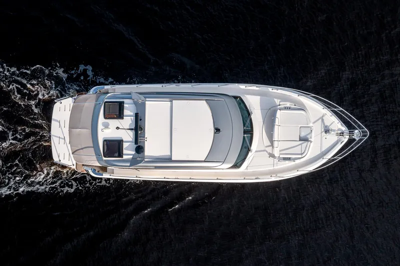 Slide: The Image of Aerial view of 2024 Riviera 4600 SY luxury yacht cruising on dark water. - 15