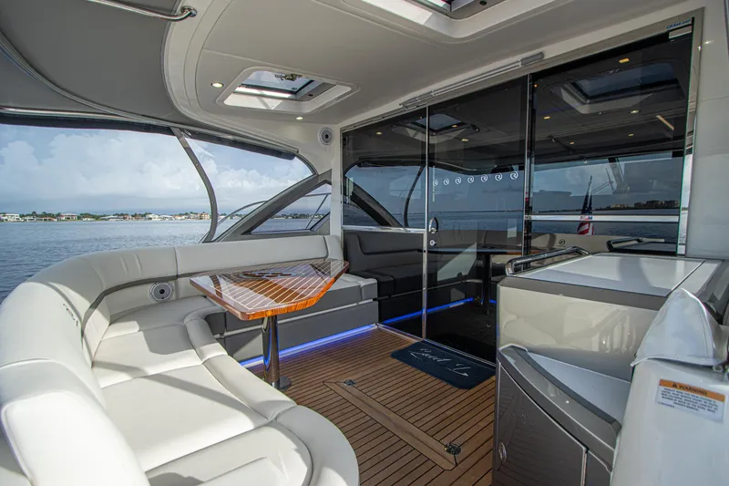 Slide: The Image of Luxurious 2024 Riviera 4600 SY yacht interior with sleek seating and modern design. - 16