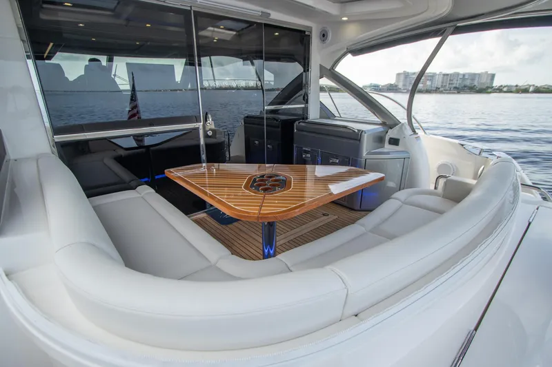 Slide: The Image of Luxurious 2024 Riviera 4600 SY yacht interior with elegant seating and wooden table. - 17