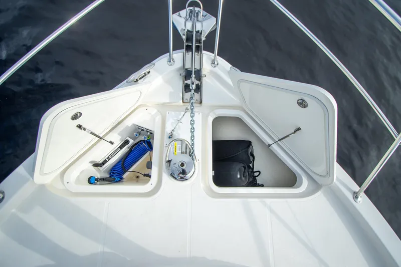 Slide: The Image of 2024 Riviera 4600 SY yacht bow storage compartments with anchor and equipment. - 19