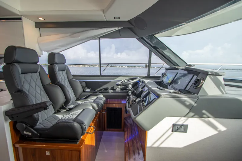 Slide: The Image of Luxurious 2024 Riviera 4600 SY yacht interior with modern helm and leather seating. - 2