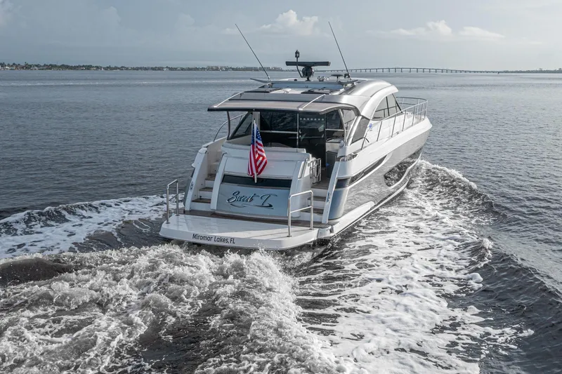 Slide: The Image of 2024 Riviera 4600 SY luxury yacht cruising on open water. - 21