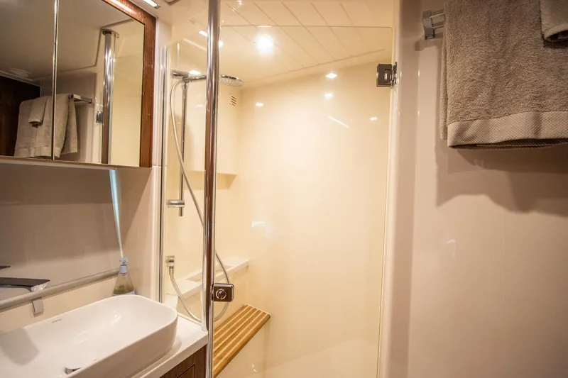 Slide: The Image of Luxurious bathroom in 2024 Riviera 4600 SY yacht with modern fixtures and elegant design. - 25
