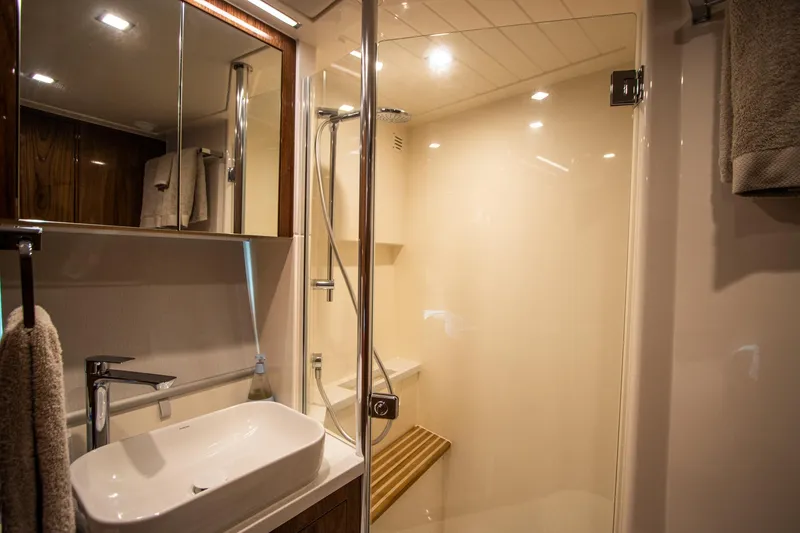 Slide: The Image of Luxurious bathroom in 2024 Riviera 4600 SY yacht with modern fixtures and spacious shower. - 26