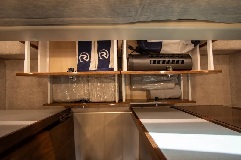 Slide: The Image of 2024 Riviera 4600 SY interior storage with shelves and branded towels. - 27