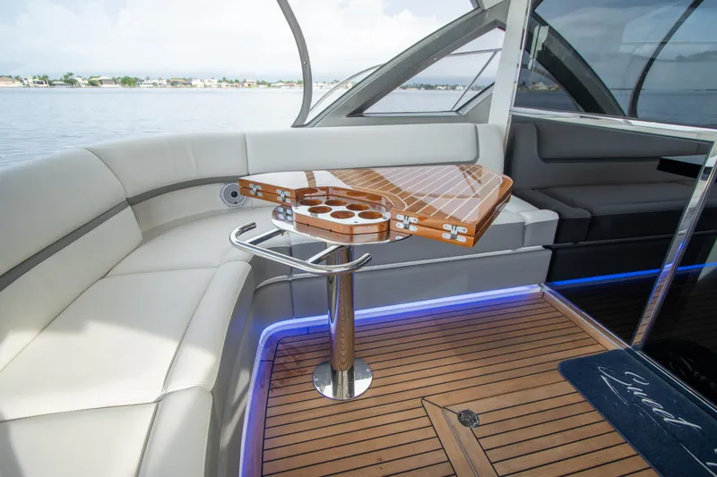 Slide: The Image of Luxurious 2024 Riviera 4600 SY yacht interior with elegant seating and wooden table. - 28