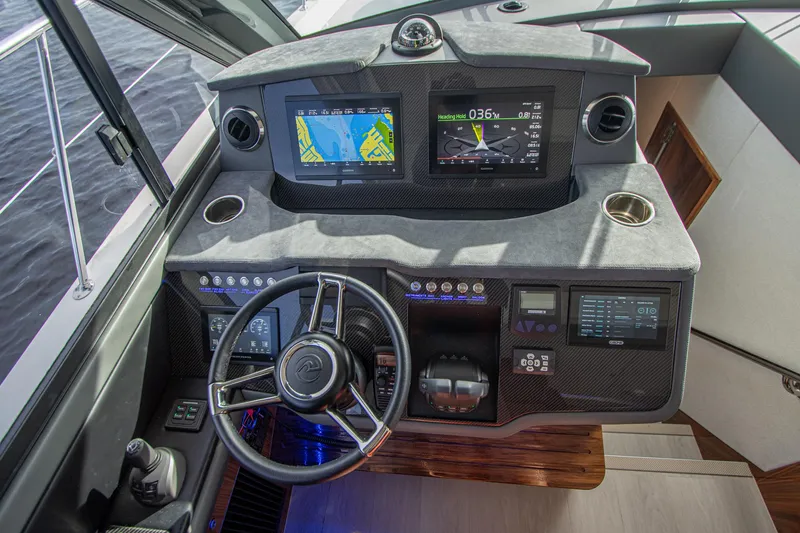 Slide: The Image of 2024 Riviera 4600 SY helm with advanced navigation displays and controls. - 3