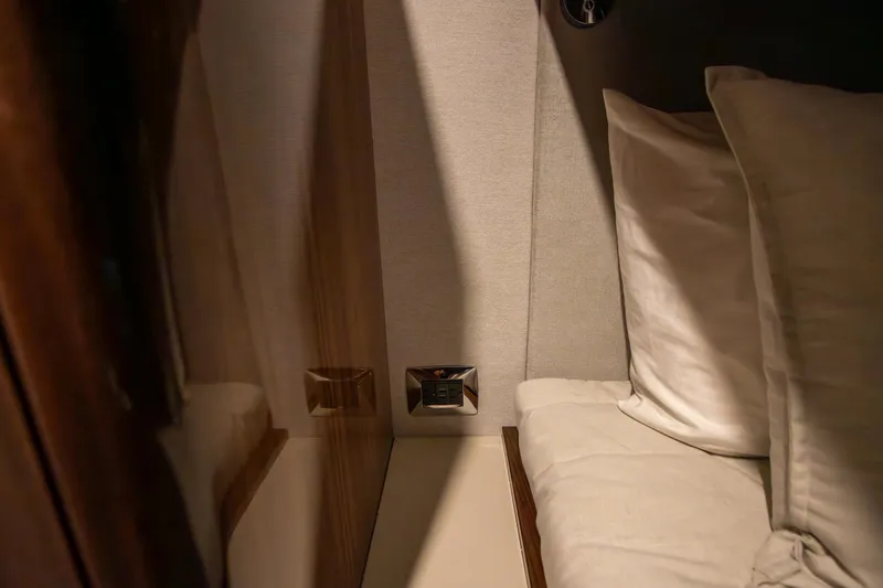 Slide: The Image of Luxurious interior cabin of 2024 Riviera 4600 SY yacht with plush bedding. - 31