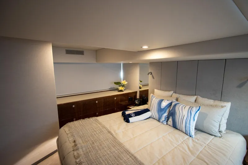 Slide: The Image of Luxurious bedroom interior of 2024 Riviera 4600 SY yacht with elegant bedding and decor. - 33