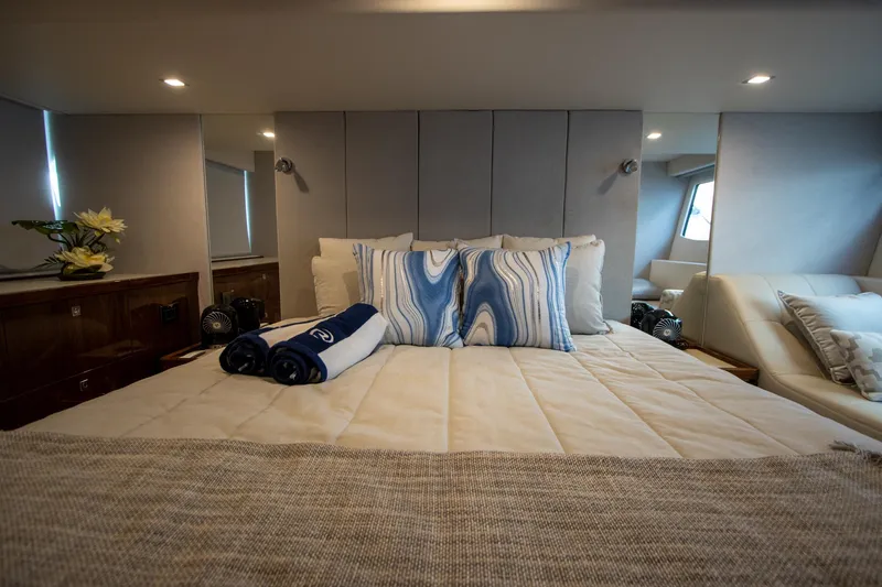 Slide: The Image of Luxurious bedroom interior of 2024 Riviera 4600 SY yacht with elegant bedding and decor. - 34