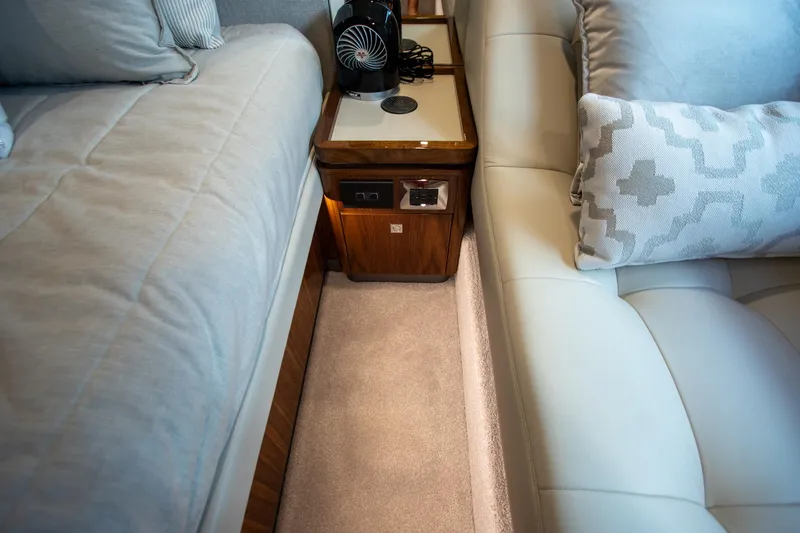 Slide: The Image of Luxurious interior of 2024 Riviera 4600 SY yacht with plush seating and elegant wood accents. - 37