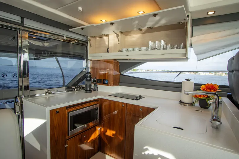 Slide: The Image of Luxurious 2024 Riviera 4600 SY yacht kitchen with modern amenities and ocean view. - 4
