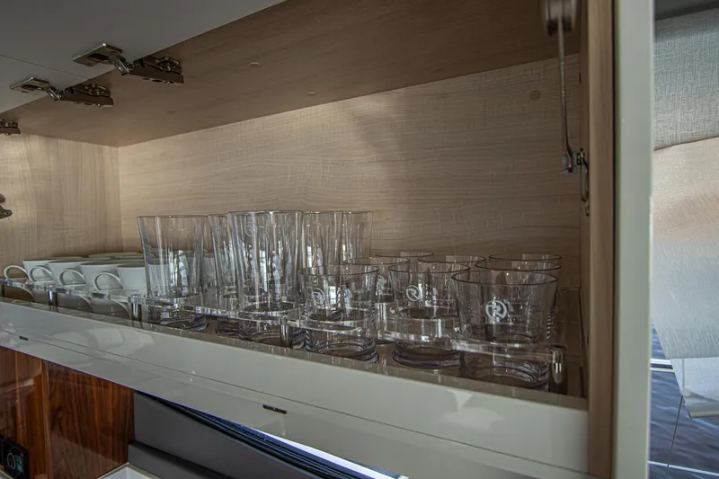 Slide: The Image of Glassware neatly arranged in a cabinet aboard 2024 Riviera 4600 SY yacht. - 41