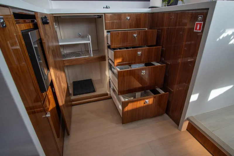 Slide: The Image of Luxurious 2024 Riviera 4600 SY yacht interior with wooden cabinetry and ample storage. - 42