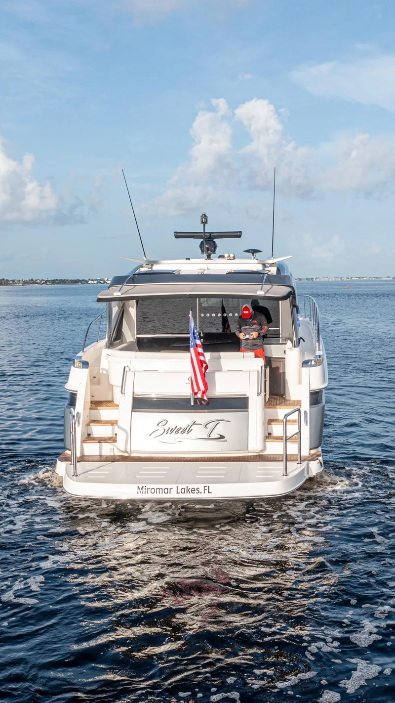 Slide: The Image of 2024 Riviera 4600 SY yacht cruising on open water, rear view. - 43