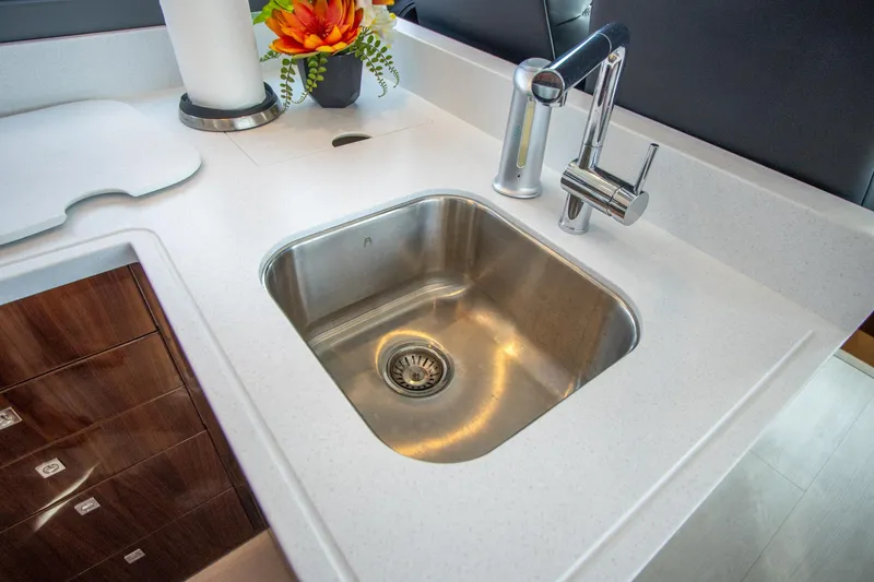 Slide: The Image of Modern kitchen sink in 2024 Riviera 4600 SY yacht with sleek faucet and countertop. - 49