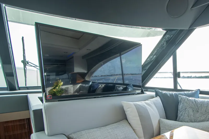 Slide: The Image of Luxurious interior of 2024 Riviera 4600 SY yacht with modern TV and plush seating. - 6