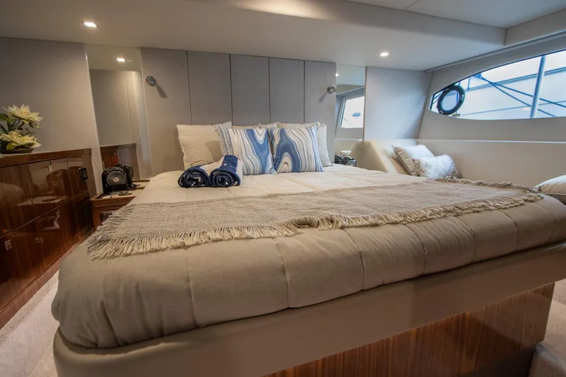 Slide: The Image of Luxurious bedroom interior of 2024 Riviera 4600 SY yacht with elegant bedding and decor. - 7