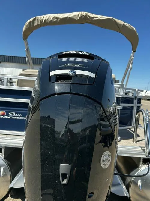 Slide: The Image of 2025 Sun Tracker Fishin' Barge 20 DLX with Mercury outboard motor, docked under clear sky. - 14