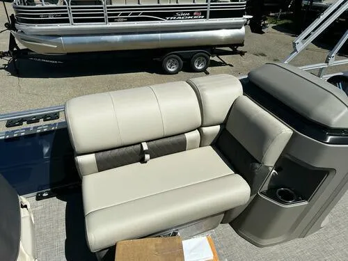Slide: The Image of 2025 Sun Tracker Fishin' Barge 20 DLX interior seating with beige upholstery. - 6