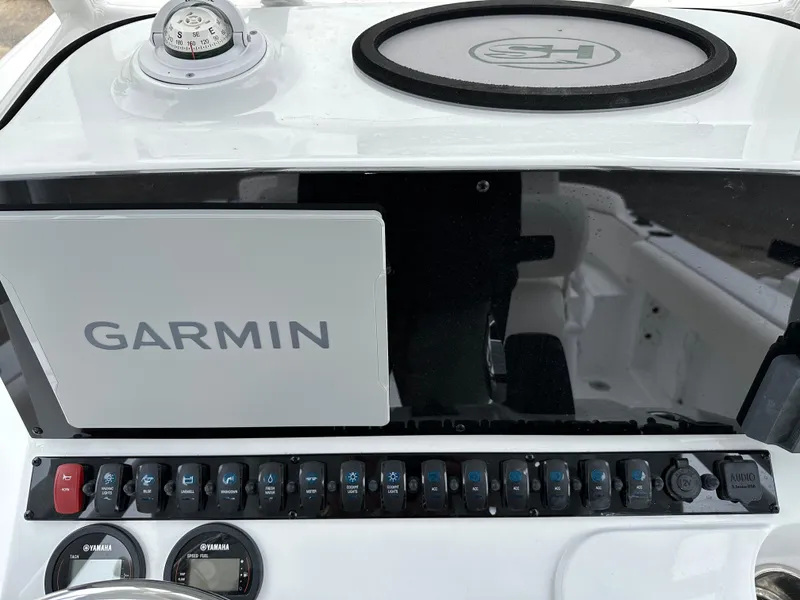 Slide: The Image of 2025 Sea Hunt Ultra 229 dashboard with Garmin navigation system and control panel. - 13