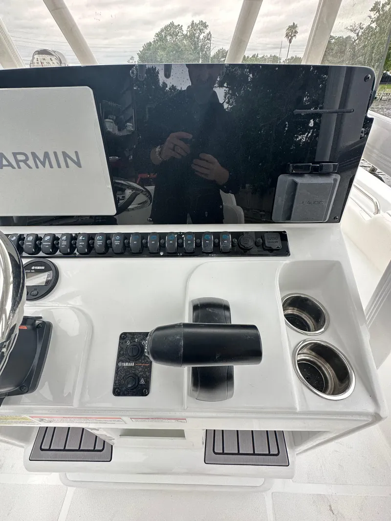 Slide: The Image of 2025 Sea Hunt Ultra 229 boat console with Garmin display and controls. - 14