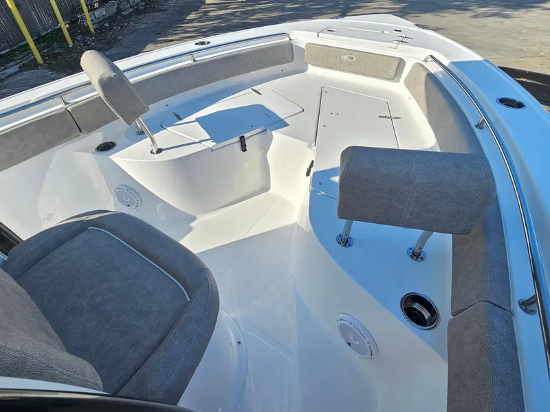 Slide: The Image of 2025 Sea Hunt Ultra 229 boat interior with cushioned seating and storage compartments. - 18
