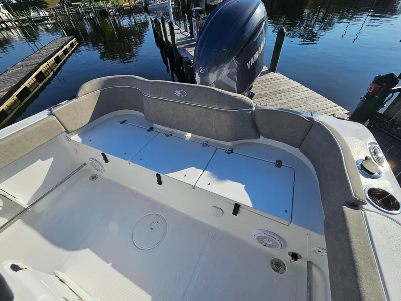 Slide: The Image of 2025 Sea Hunt Ultra 229 boat interior with Yamaha engine at dock. - 21