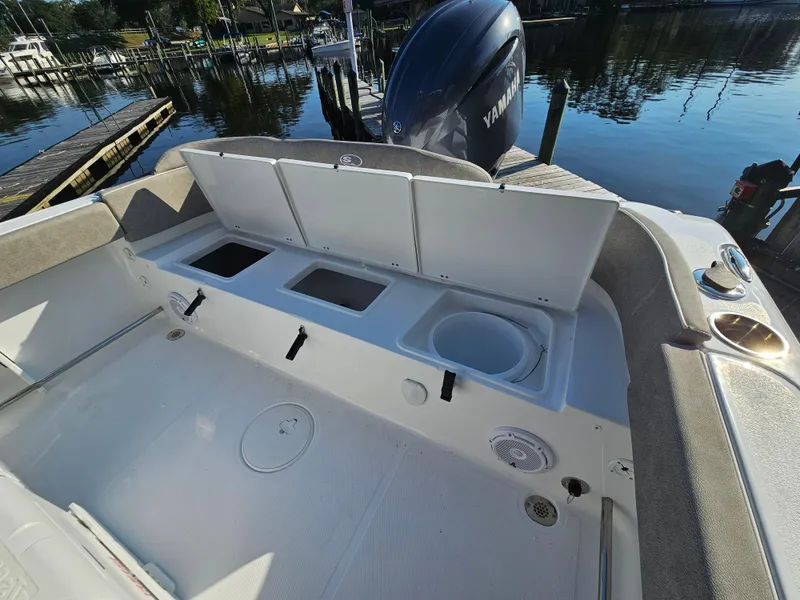 Slide: The Image of 2025 Sea Hunt Ultra 229 boat interior with storage compartments and Yamaha engine. - 22