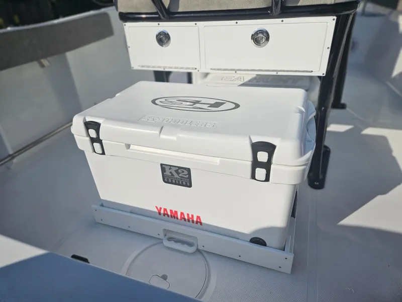 Slide: The Image of 2025 Sea Hunt Ultra 229 boat interior with Yamaha cooler and storage drawers. - 24