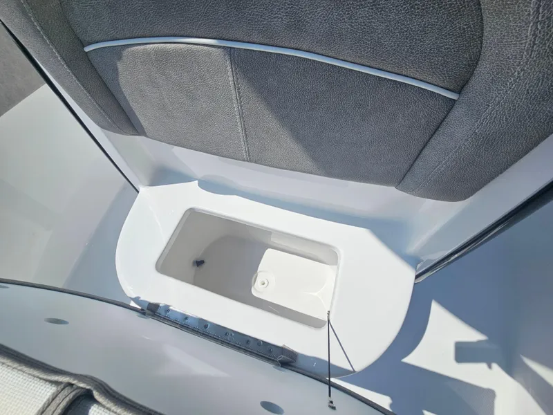 Slide: The Image of 2025 Sea Hunt Ultra 229 boat storage compartment with cushioned seating. - 28