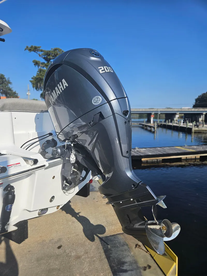 Slide: The Image of Yamaha 200 outboard motor on 2025 Sea Hunt Ultra 229 boat, docked by the water. - 5