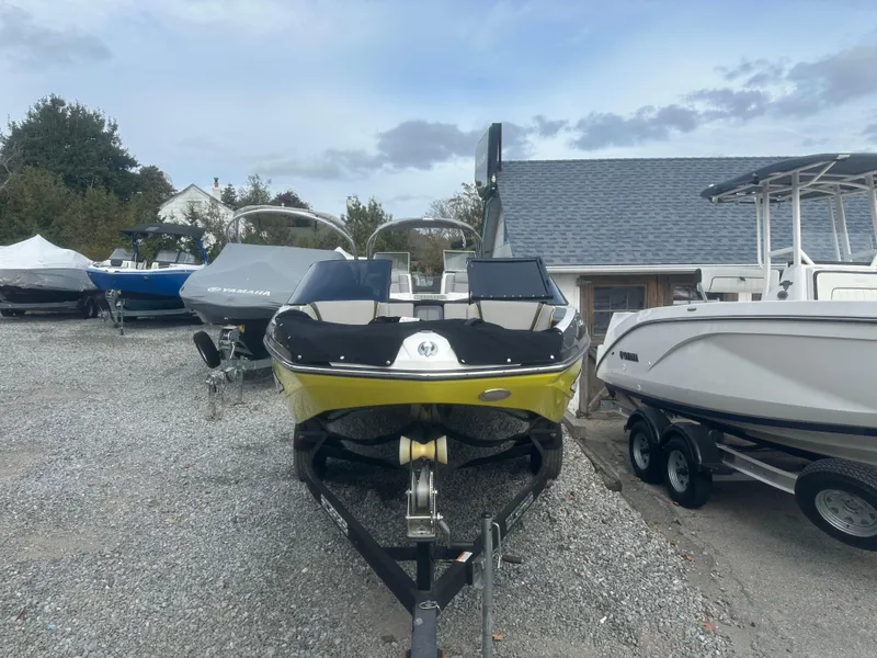 Slide: The Image of 2020 Scarab 195 ID boat on trailer in outdoor lot. - 4