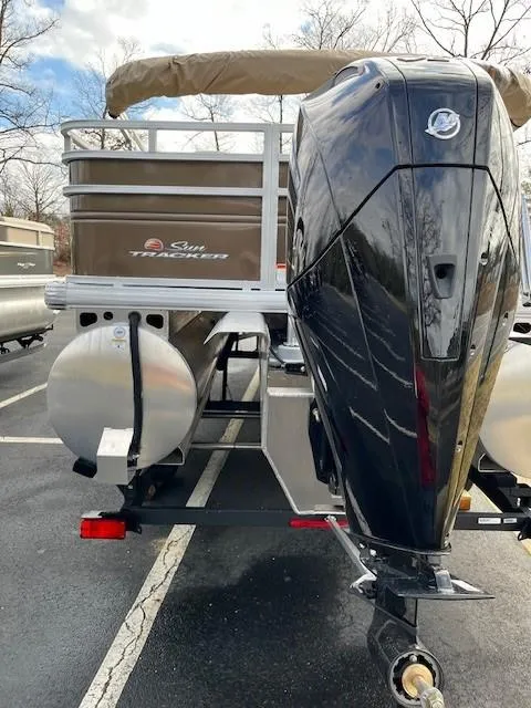 Slide: The Image of 2025 Sun Tracker SportFish 22 XP3 pontoon boat with powerful outboard motor. - 2
