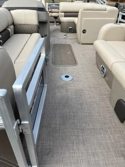 Slide: The Image of 2025 Sun Tracker SportFish 22 XP3 interior with beige seating and carpeted flooring. - 3