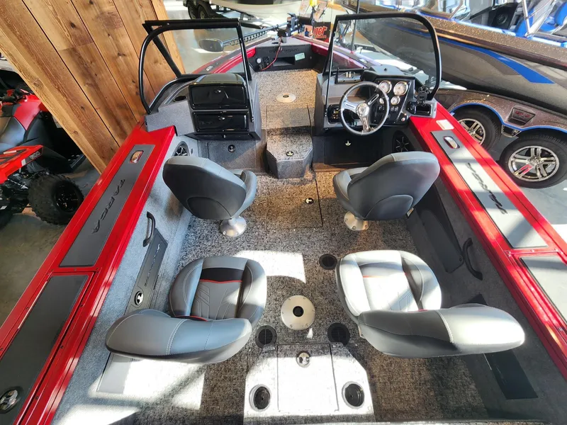 Slide: The Image of 2025 Tracker Targa V-18 WT boat interior with four seats and modern dashboard. - 2
