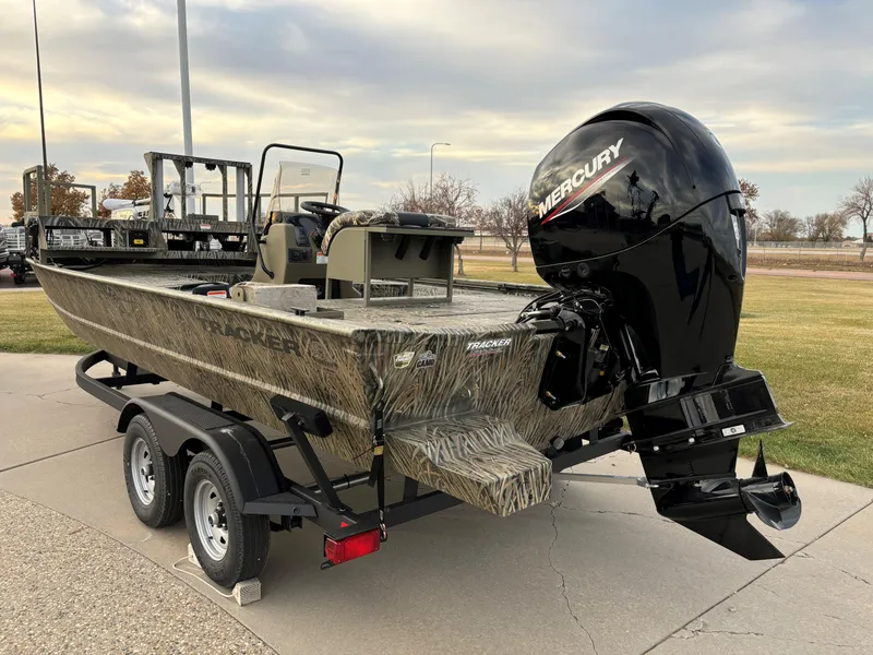 Slide: The Image of 2025 Tracker Grizzly 2072 CC Sportsman boat with Mercury engine on trailer. - 2