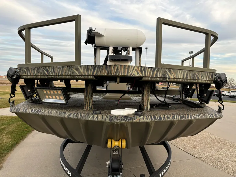 Slide: The Image of 2025 Tracker Grizzly 2072 CC Sportsman boat, front view, camo design, on trailer. - 3