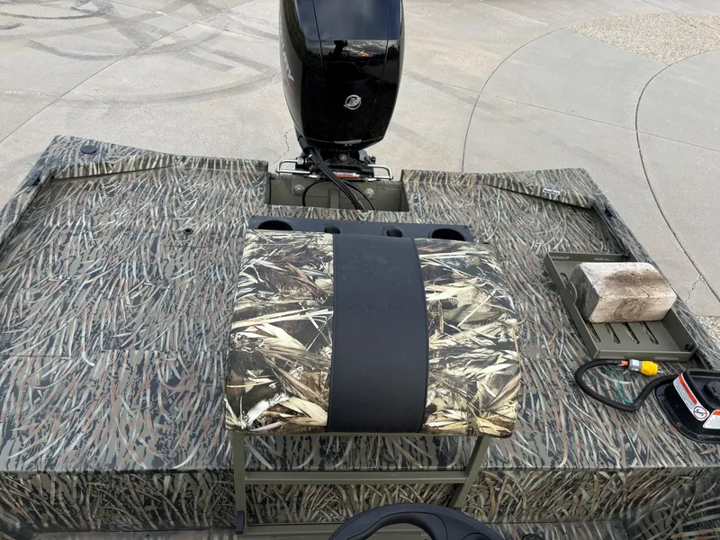 Slide: The Image of 2025 Tracker Grizzly 2072 CC Sportsman boat with camo seating and motor. - 8