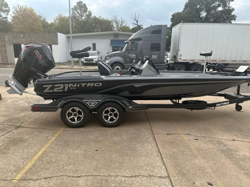 Slide: The Image of 2025 Nitro Z21 XL Pro boat on trailer, parked in lot. - 2