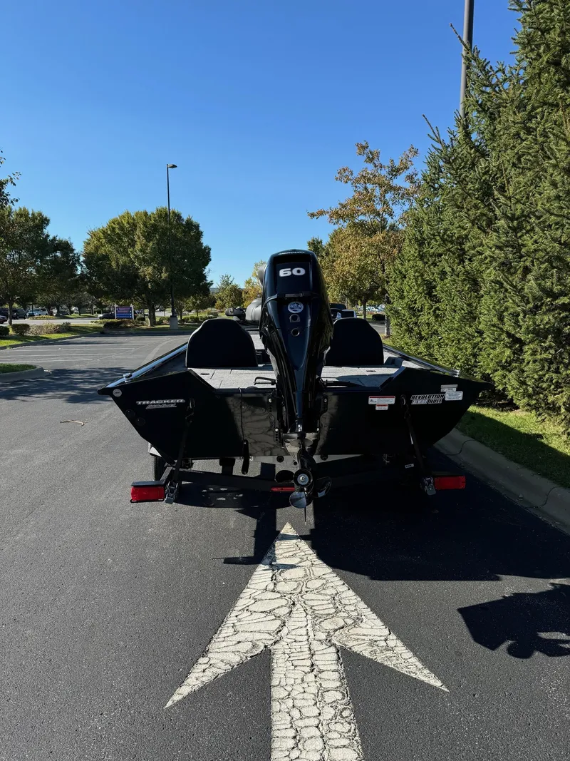 Slide: The Image of 2025 Tracker Pro Team 175 boat on trailer, parked on a sunny street. - 5